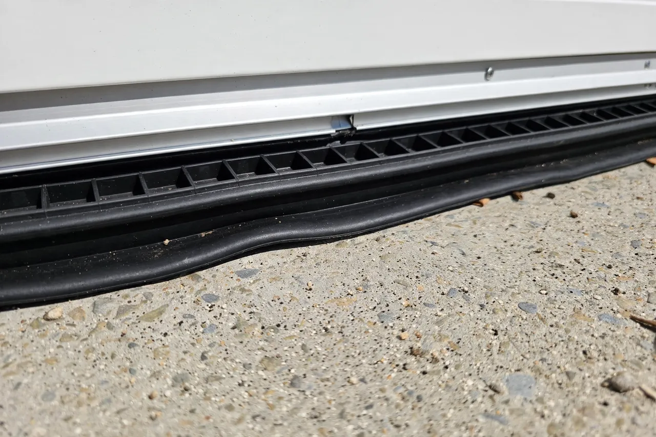 Chimney Caps in Provo, UT: new rubber seal along the bottom of a garage door